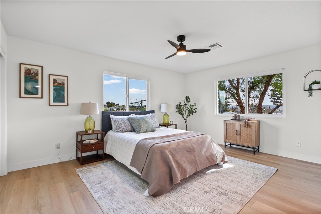 5658 Prancing Deer Road Paso Robles, CA 93446 - Photo 12 of 31 a bedroom with a large bed and a chandelier