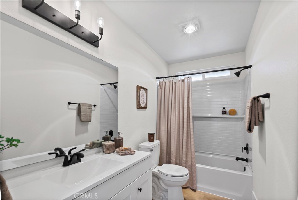 5658 Prancing Deer Road Paso Robles, CA 93446 - Photo 20 of 31 a bathroom with a sink a toilet and a mirror