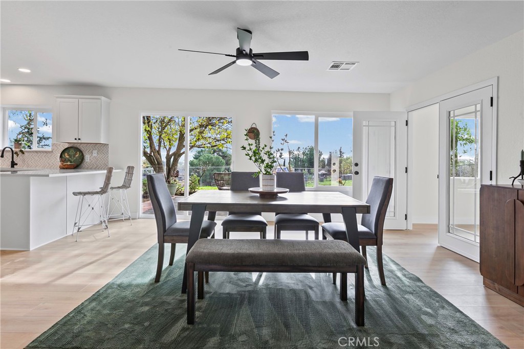 5658 Prancing Deer Road Paso Robles, CA 93446 - Photo 9 of 31 a view of a dining room with furniture window and wooden floor