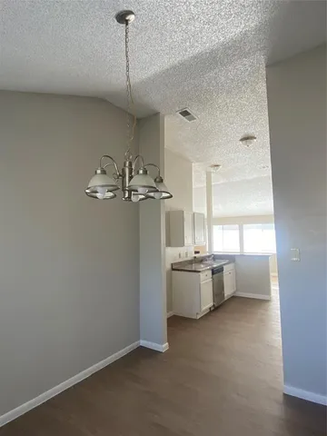 a room with window and chandelier
