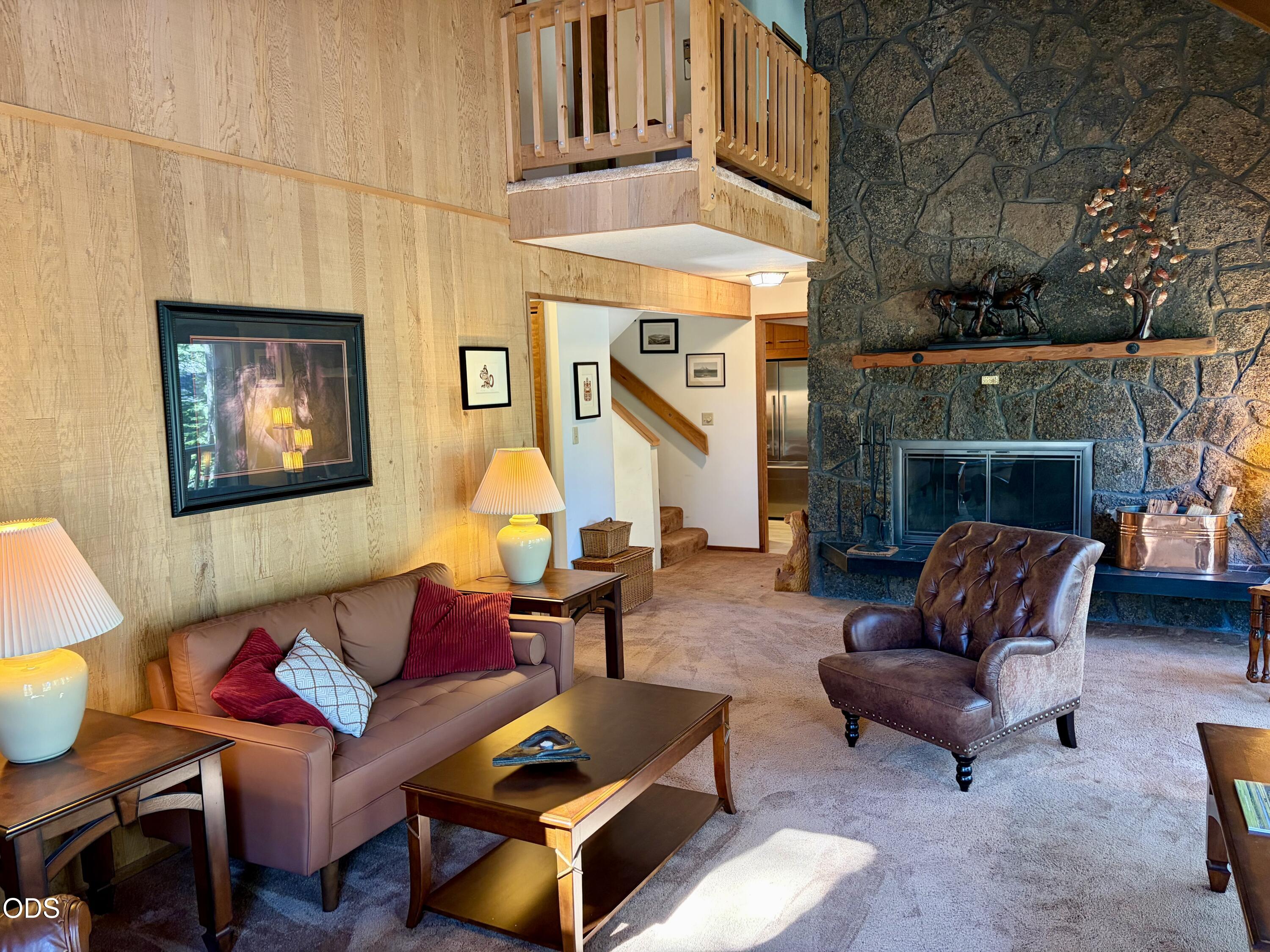 13251 Snowbrush, Unit GH 266 Black Butte Ranch, OR 97759 - Photo 3 of 37 a living room with furniture a fireplace and a flat screen tv