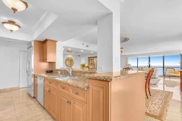 a kitchen with stainless steel appliances granite countertop a refrigerator and a stove