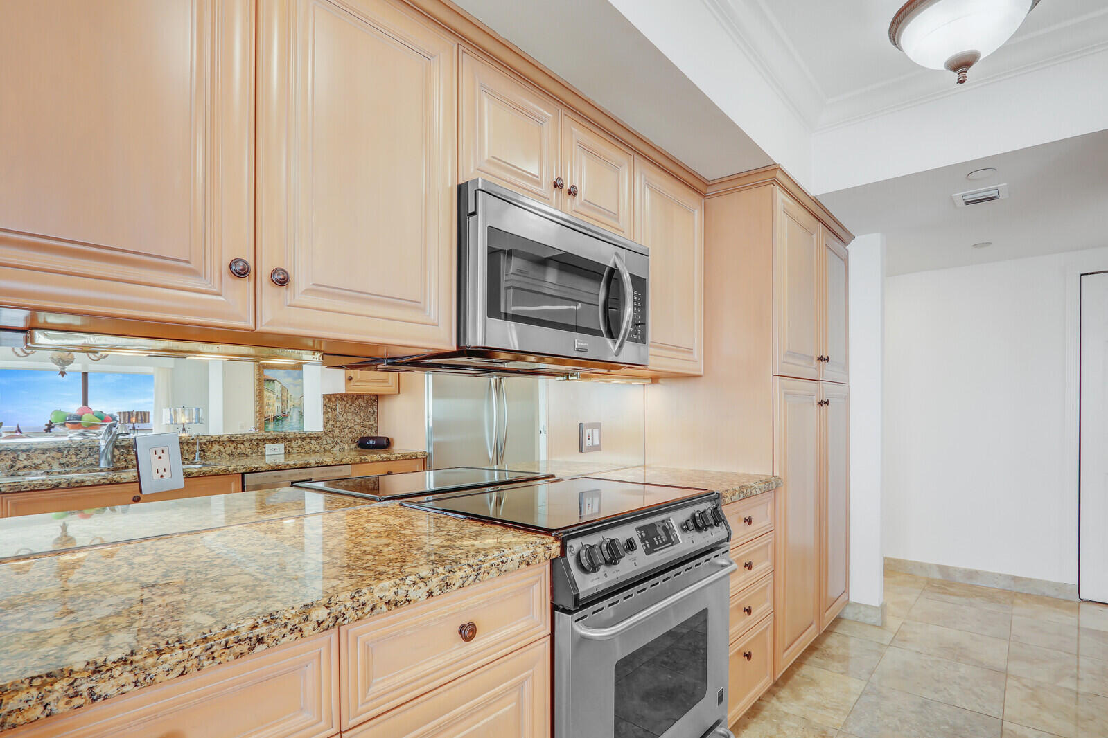 4000 North Ocean Drive, Unit 1702 Singer Island, FL 33404 - Photo 18 of 48 a kitchen with stainless steel appliances granite countertop a sink and a stove