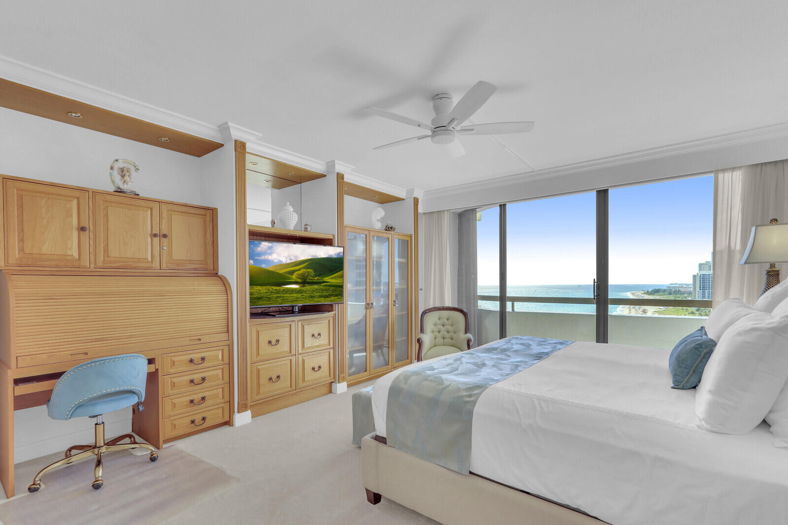 4000 North Ocean Drive, Unit 1702 Singer Island, FL 33404 - Photo 23 of 48 a bedroom with a large bed and a flat tv screen on dresser