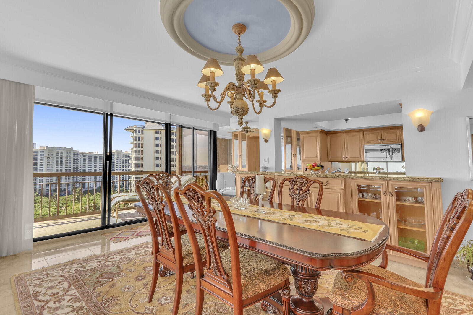 4000 North Ocean Drive, Unit 1702 Singer Island, FL 33404 - Photo 9 of 48 a view of a dining room with furniture wooden floor and chandelier