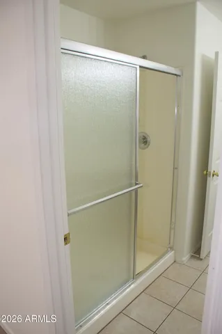 a bathroom with a glass shower door