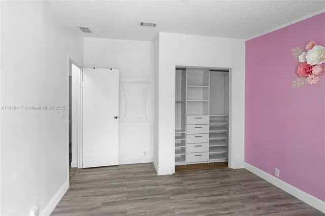 an empty room with wooden floor