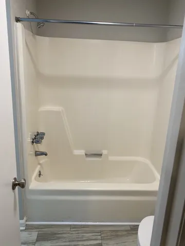a bathroom with a shower and a bath tub