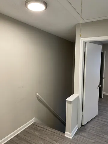 a view of a room with wooden floor and bench