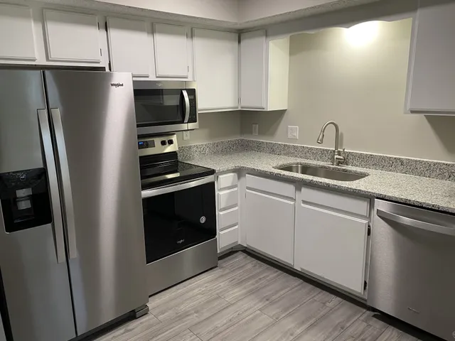 a kitchen with a sink and steel stainless steel appliances