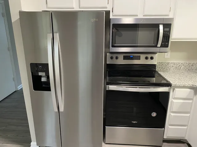 a stove top oven sitting inside of a kitchen