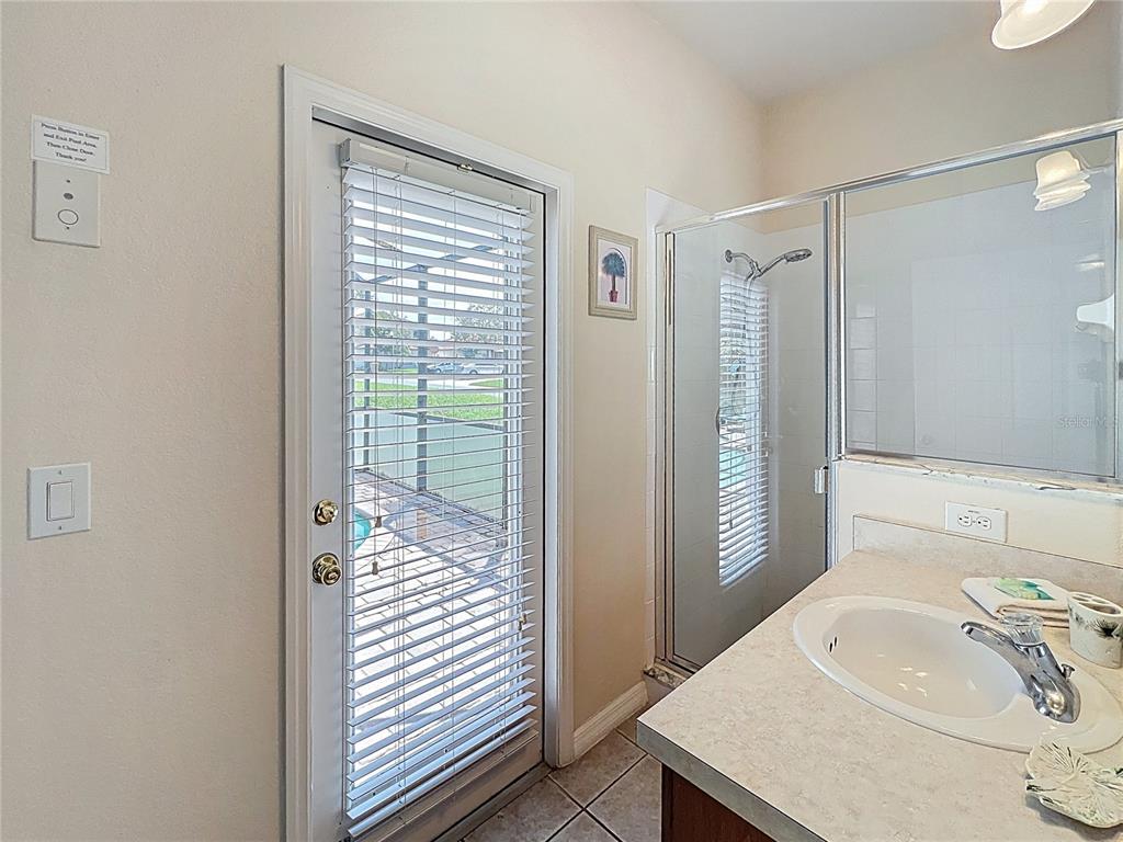 102 Sandy Point Way Clermont, FL 34714 - Photo 16 of 33 a bathroom with a sink a toilet and shower