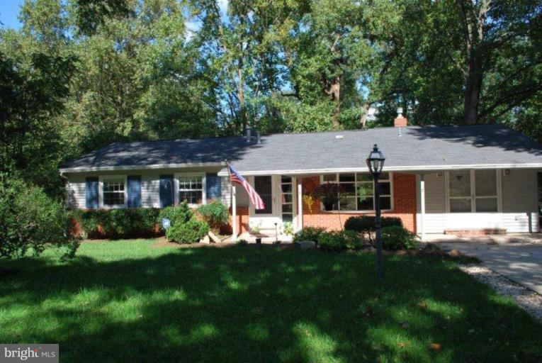 13233 Clifton Road Silver Spring, MD 20904 - Photo 1 of 30 a front view of a house with a yard table and chairs