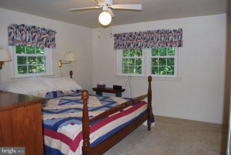 13233 Clifton Road Silver Spring, MD 20904 - Photo 14 of 30 a bed room with a bed and a window