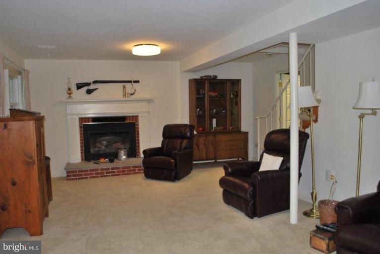 13233 Clifton Road Silver Spring, MD 20904 - Photo 22 of 30 a living room with furniture and a fireplace