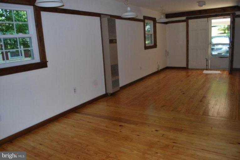 13233 Clifton Road Silver Spring, MD 20904 - Photo 27 of 30 a view of an empty room with wooden floor and a window