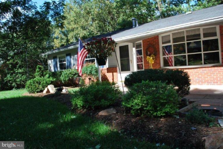 13233 Clifton Road Silver Spring, MD 20904 - Photo 29 of 30 a front view of a house with a yard and potted plants