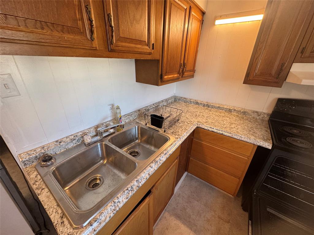 739 Iberis Road South, Unit 2 Abilene, TX 79606 - Photo 3 of 6 a kitchen with a stove and a microwave