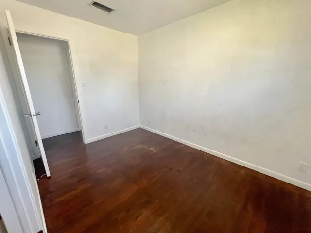 an empty room with wooden floor