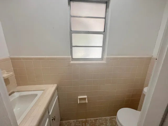a bathroom with a toilet and a sink