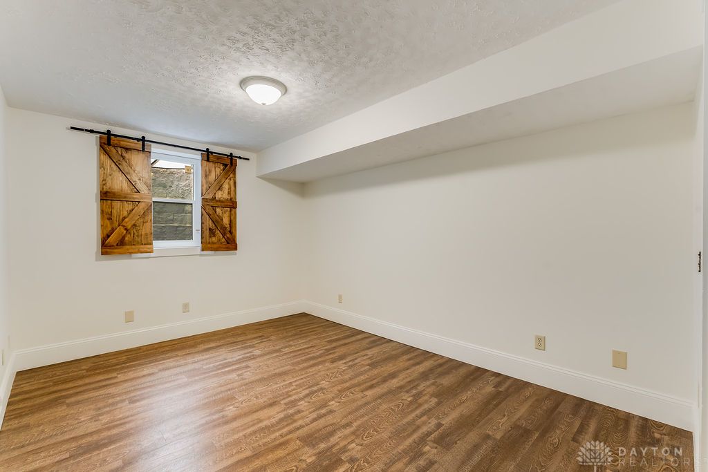 7400 Cook-Jones Road Waynesville, OH 45068 - Photo 49 of 72 This versatile room features warm flooring and natural light, perfect for a cozy retreat or dynamic workspace.