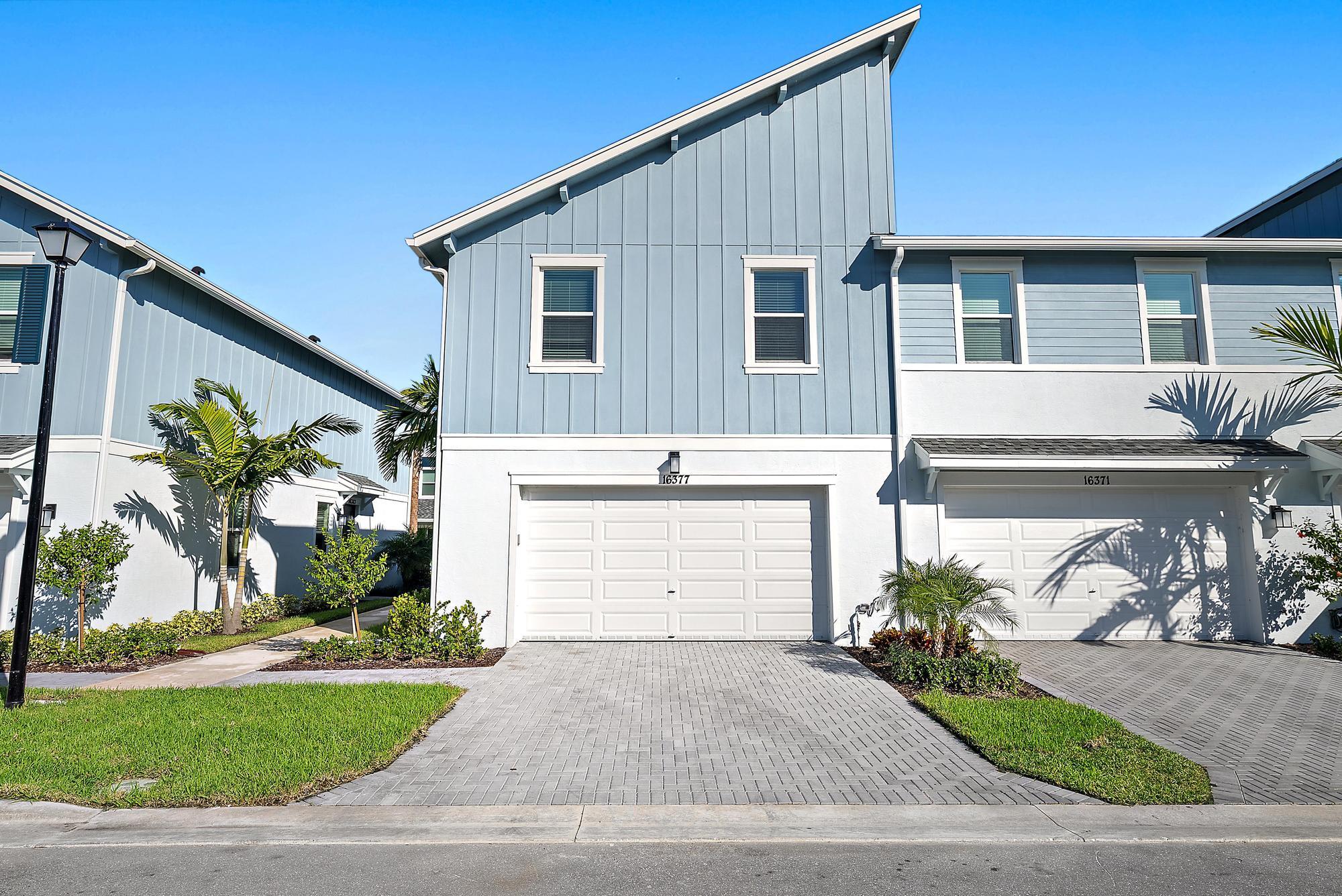 16377 Biltmore Landing Loxahatchee, FL 33470 - Photo 5 of 23 a front view of a house with a yard and garage