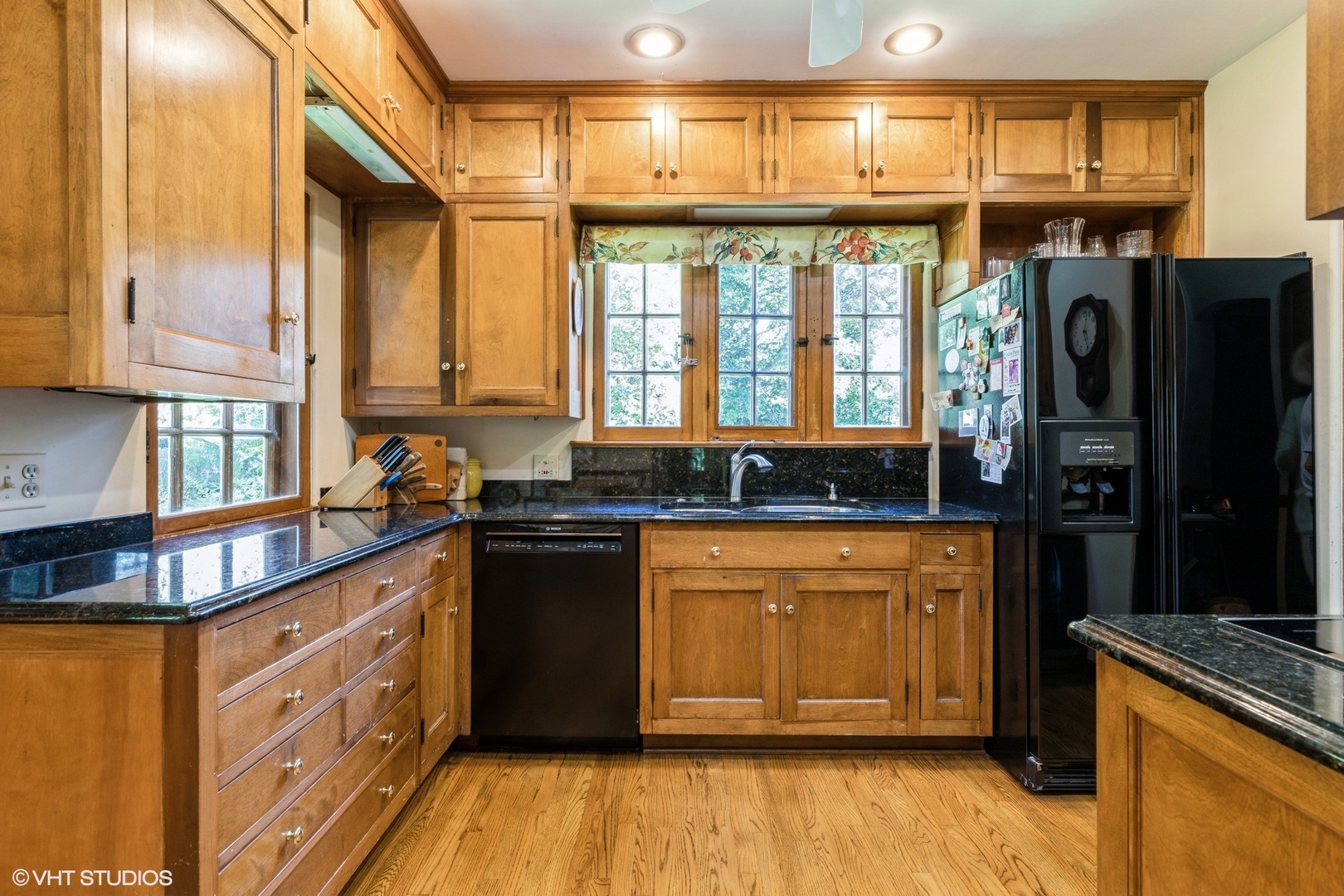 753 York Road Glenview, IL 60025 - Photo 5 of 17 a kitchen with stainless steel appliances granite countertop a refrigerator a sink dishwasher a stove and white countertops with wooden floor