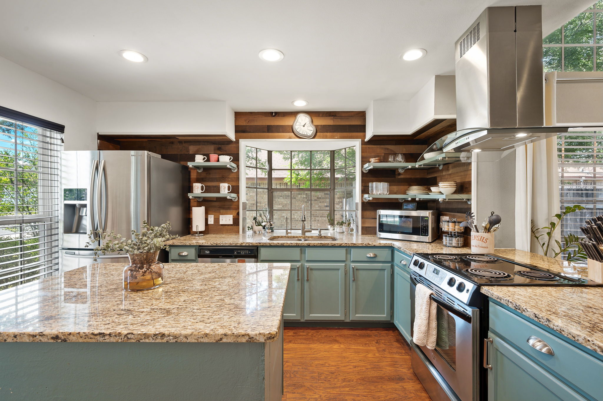 705 Canyon Bend Road Pflugerville, TX 78660 - Photo 6 of 23 a kitchen with stainless steel appliances granite countertop a sink and a stove