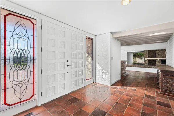 a large kitchen with a large counter top and stainless steel appliances