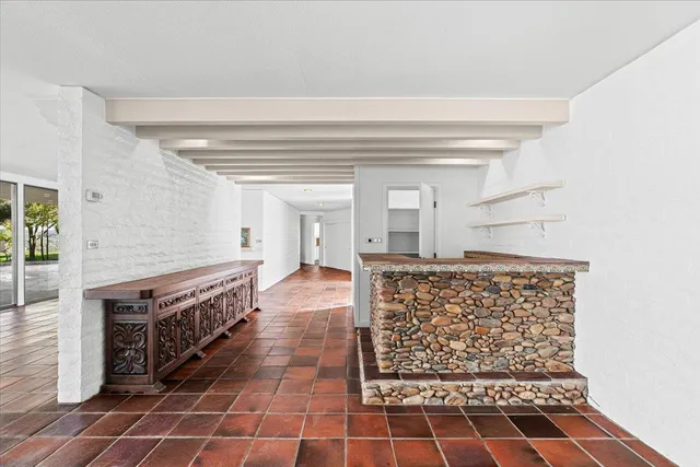 a kitchen with granite countertop a stove and a shower