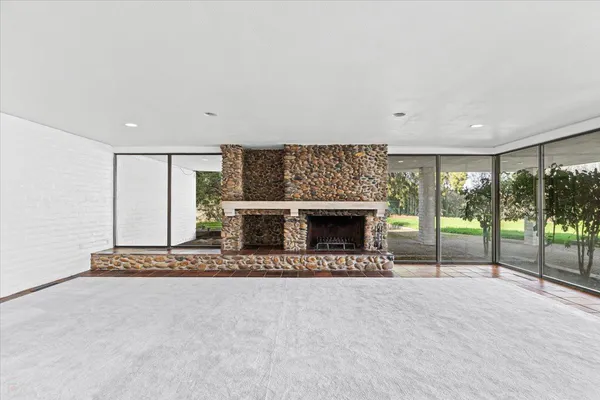 an empty room with sliding glass door and painted walls