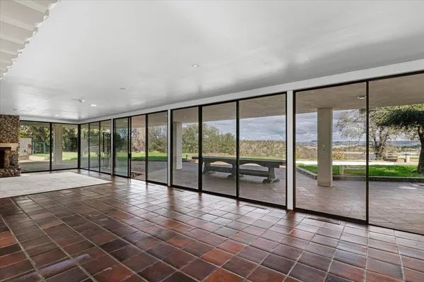 a view of a room with sliding glass door and mountain view