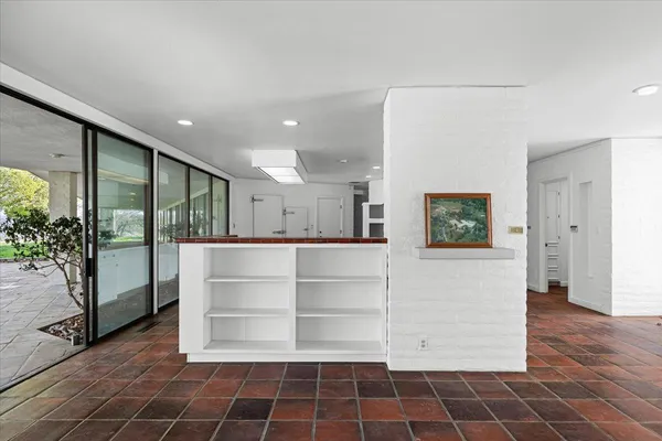 a bathroom with a granite countertop sink a toilet a mirror and shower