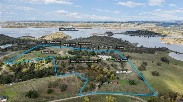an aerial view of a house with a yard and large trees