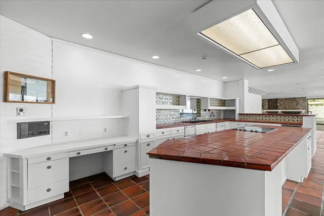 a bathroom with a toilet a sink and a large window