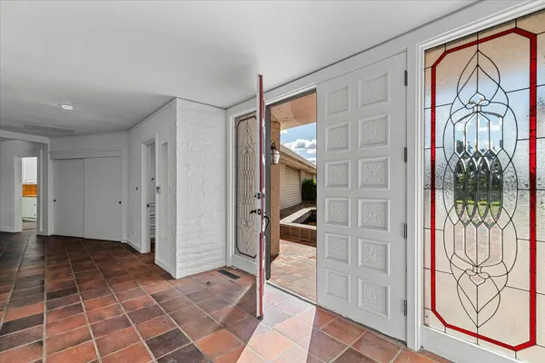 a view of a yard with flower plants and large tree