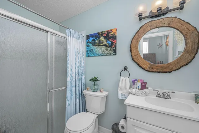 a bathroom with a toilet a sink and a mirror