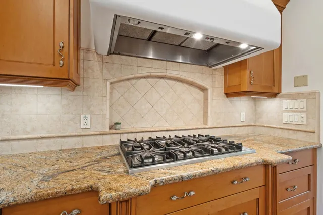 a bathroom with a granite countertop sink a mirror and shower