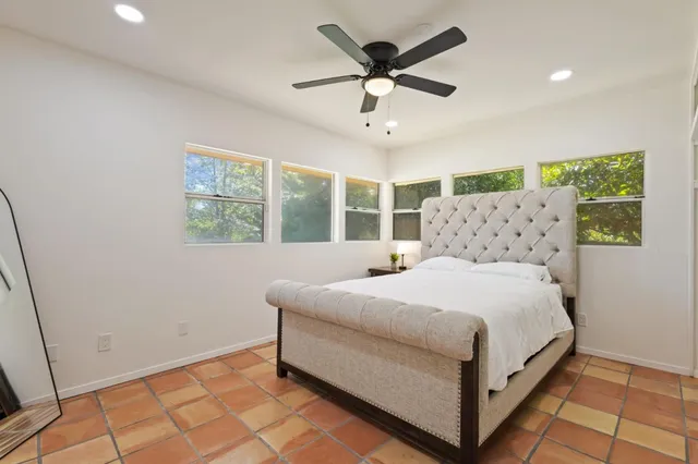 a bedroom with a large bed and a window