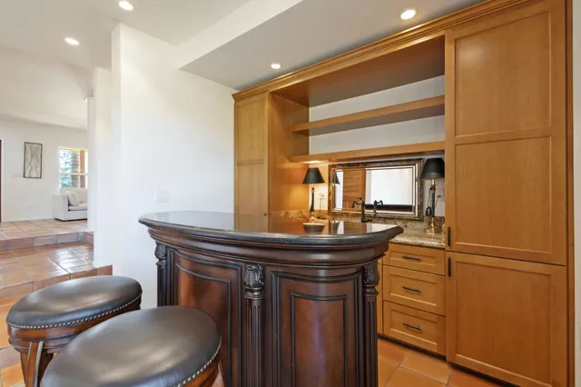 a bathroom with a granite countertop sink mirror vanity and toilet