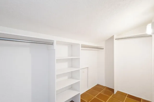 a view of a house with porch and garden