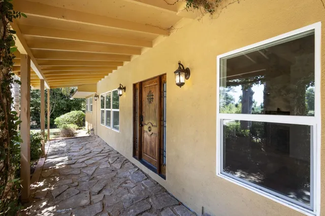 a view of a porch with a table and a potted plant