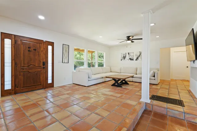 a living room with furniture and a flat screen tv