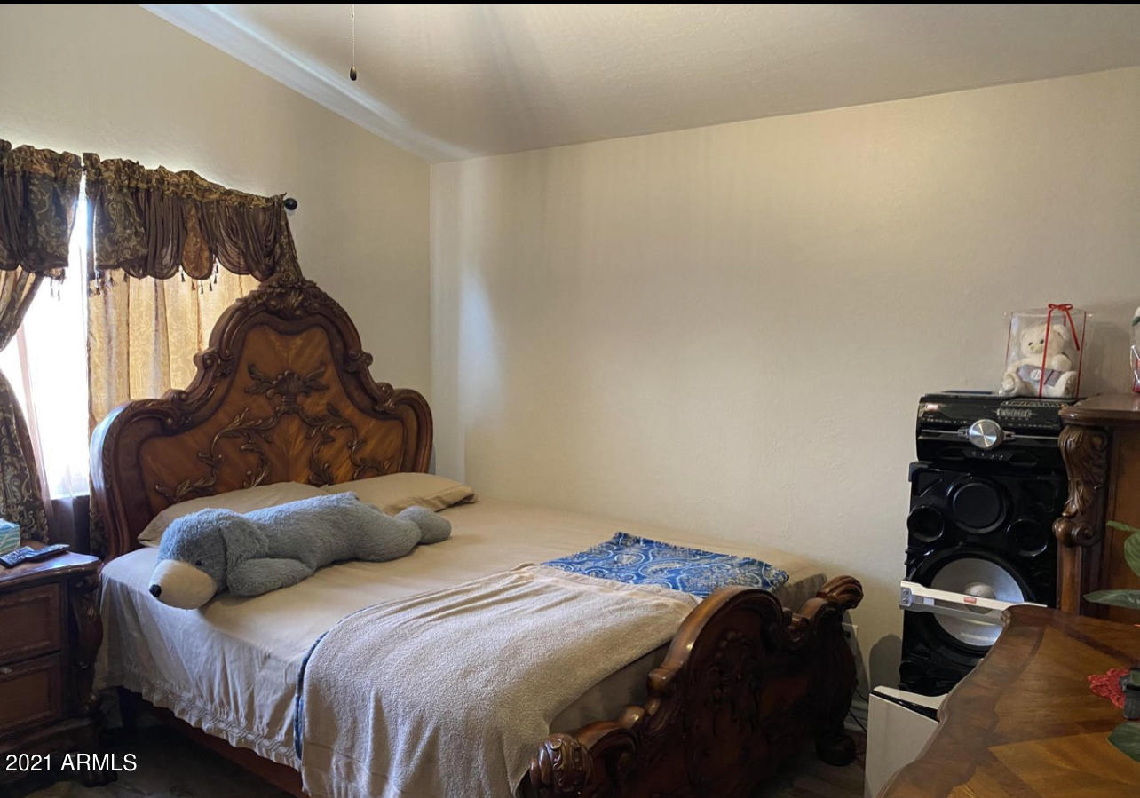 3310 West Fraktur Road Phoenix, AZ 85041 - Photo 11 of 17 a bedroom with a bed and dresser