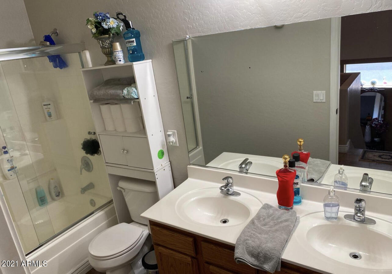 3310 West Fraktur Road Phoenix, AZ 85041 - Photo 15 of 17 a bathroom with a sink toilet and shower
