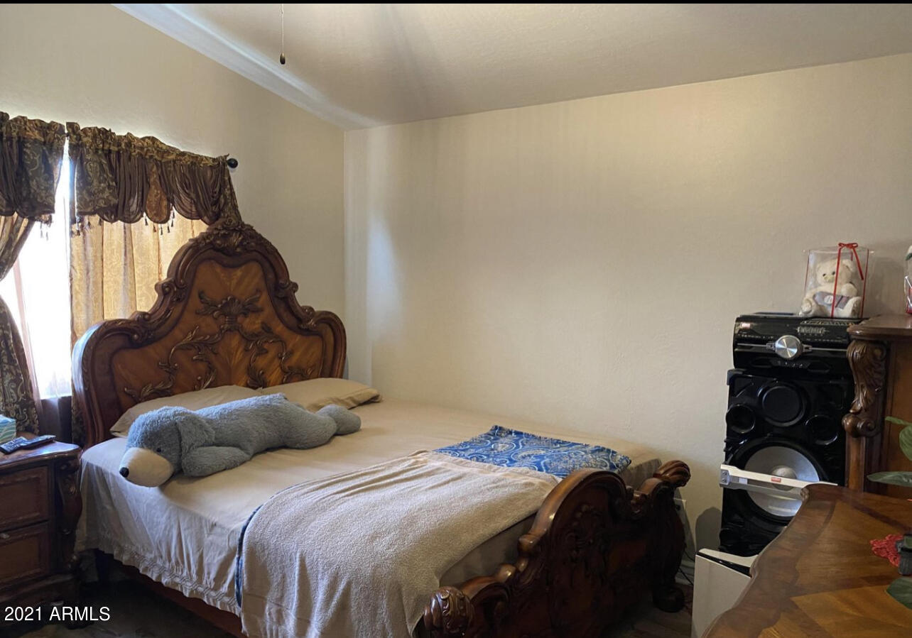 3310 West Fraktur Road Phoenix, AZ 85041 - Photo 16 of 17 a bedroom with a bed and a closet