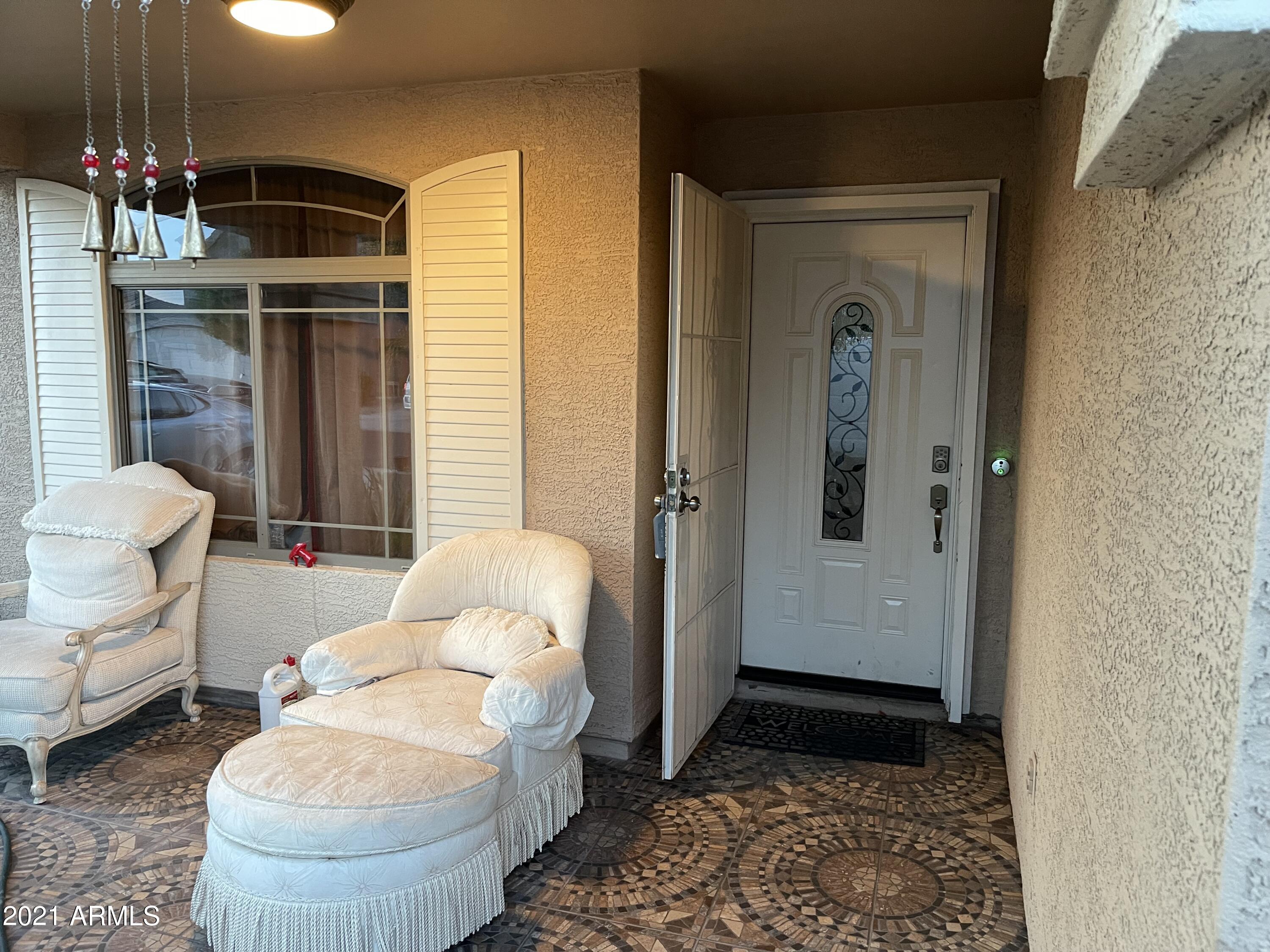 3310 West Fraktur Road Phoenix, AZ 85041 - Photo 2 of 17 a living room with furniture and a rug