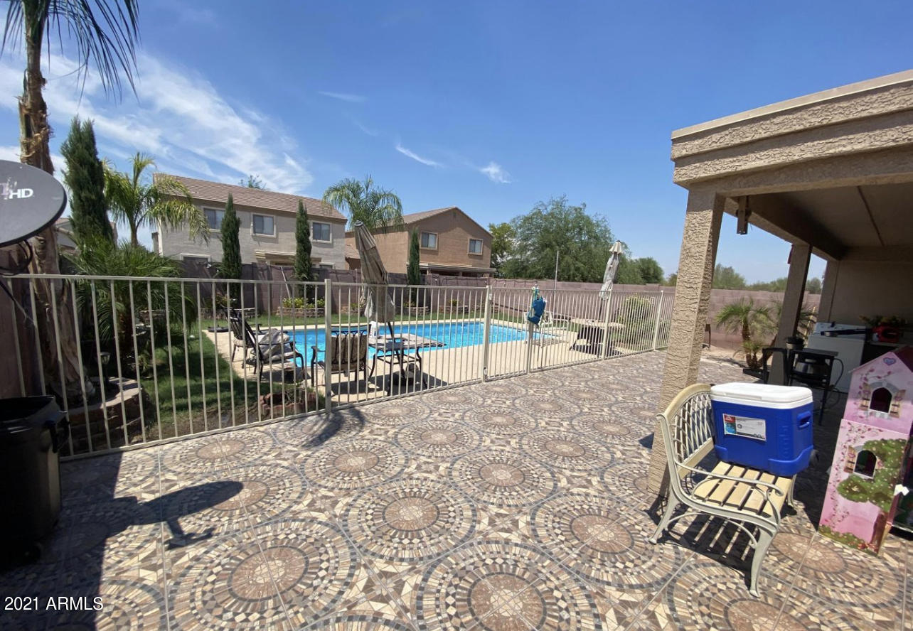 3310 West Fraktur Road Phoenix, AZ 85041 - Photo 6 of 17 a view of roof deck with table and chairs potted plants with wooden fence