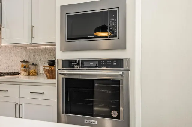 a hallway with white cabinets
