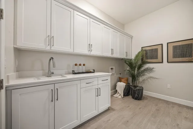 a view of a kitchen with sink and cabinets